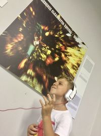 Low angle view of woman holding umbrella