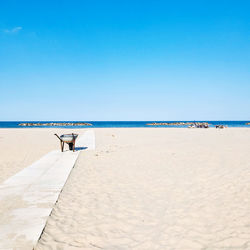 Scenic view of beach against blue sky