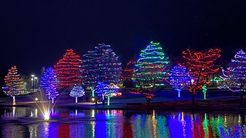 Illuminated building with reflection in water at night