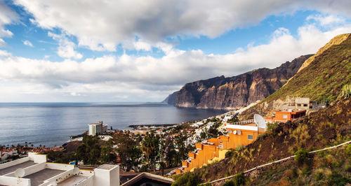 Panoramic view of town against cloudy sky