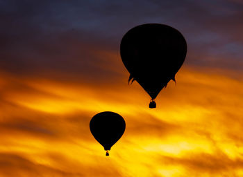 Low angle view of hot air balloon against orange sky