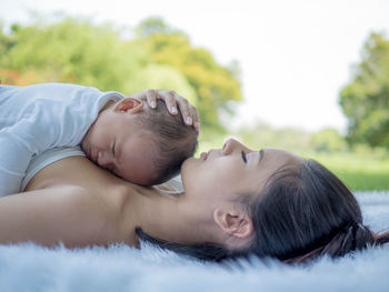 Portrait of young couple lying outdoors