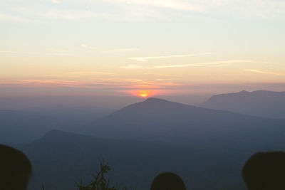 Scenic view of silhouette mountains against sky at sunset