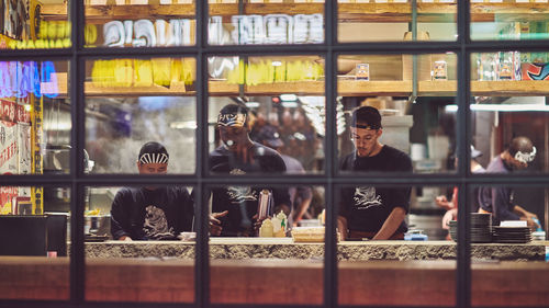 Reflection of people on glass window