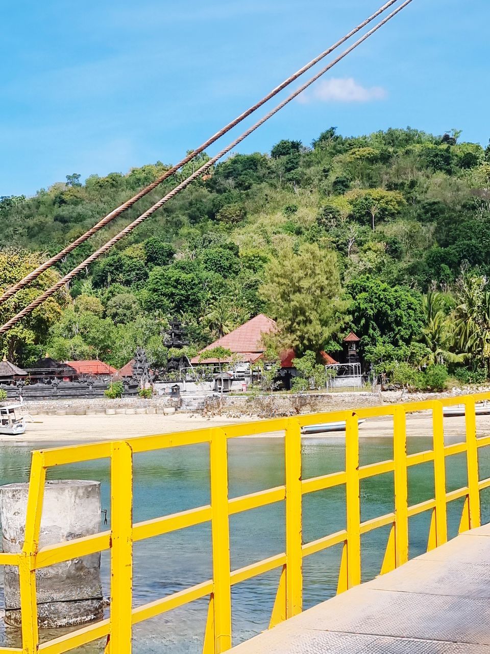 plant, nature, tree, sky, water, architecture, vacation, day, transportation, no people, railing, beauty in nature, land, outdoors, mountain, scenics - nature, built structure, cable, sea, travel destinations, yellow, travel, city, bridge, tranquility, landscape, tourism, environment, coast, blue, tranquil scene