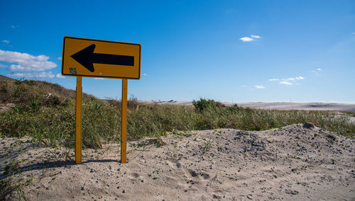 Road sign against clear sky