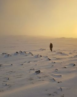 Scenic view of men on snow against clear cloudy sunny sky