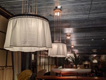 Close-up of illuminated pendant lights at restaurant