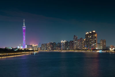 Illuminated city at waterfront