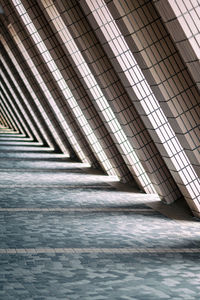 Empty corridor by columns in building