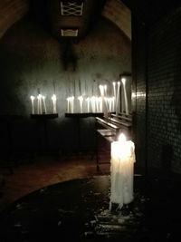 Close-up of illuminated candles on cake