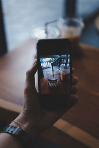 Midsection of person using mobile phone