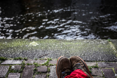 Low section of person standing on tiled floor