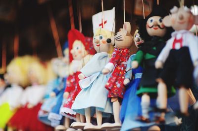 Close-up of dolls hanging for sale at market