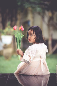 Woman looking at flower bouquet