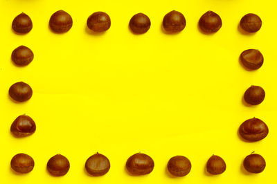 Nuts arranged on yellow background