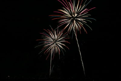 Low angle view of firework display at night