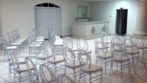 Empty chairs and tables in glass