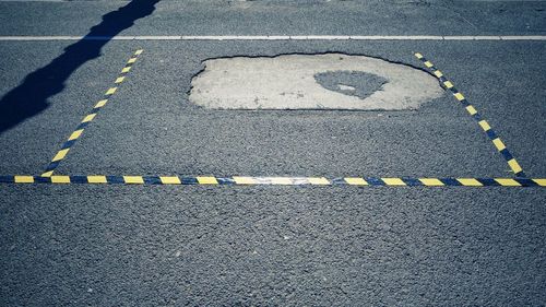 High angle view of arrow sign on road