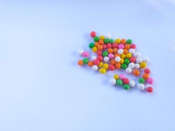 High angle view of multi colored pencils on white background