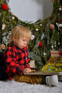 Portrait of cute baby boy sitting on table