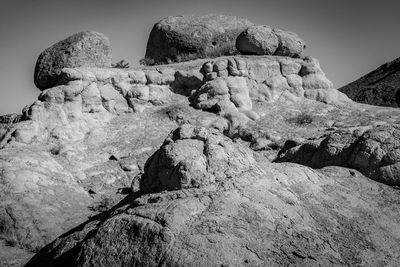 Low angle view of rock formation against sky