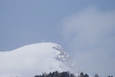 Low angle view of snowcapped mountain against sky