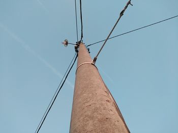 Low angle view of telephone pole against clear sky