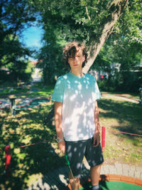 Rear view of boy standing in park