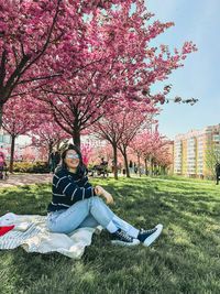 Rear view of woman sitting on field