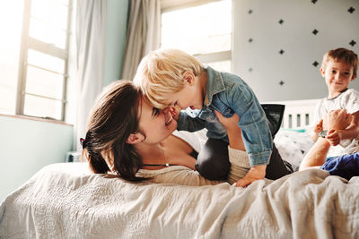 Mother embracing with son at home