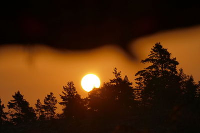 Low angle view of silhouette trees against sky during sunset