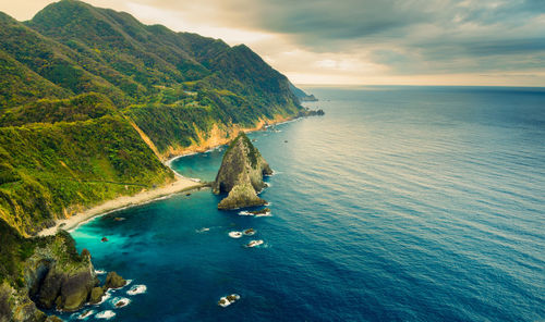 Wide-angle shot of the steep, rocky kumomi coastline with few sea stacks along the coast.
