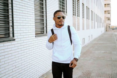 Young man wearing sunglasses standing outdoors