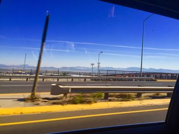 Cars on road against blue sky