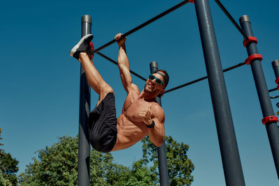 Low angle view of man standing against sky