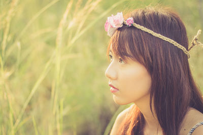 Close-up of beautiful young woman wearing wreath