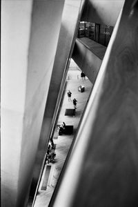 High angle view of people walking on escalator in building