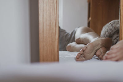 Woman sleeping on bed at home