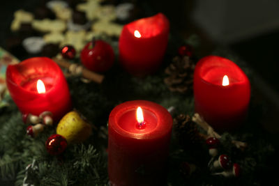 High angle view of lit candles on christmas decoration