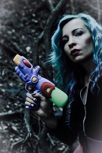 Portrait of woman holding squirt gun