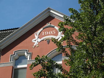 Low angle view of building against clear blue sky