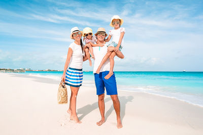 Portrait of people on beach against sky