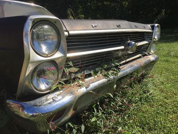 Close-up of vintage car on field