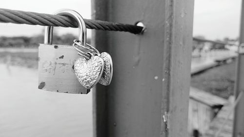 Close-up of love lock attached on railing