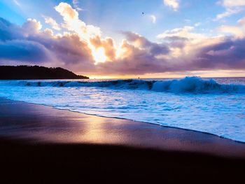 Scenic view of beach against sky during sunset