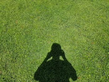 Shadow of woman on field