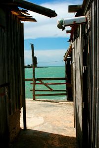 Pier on sea against cloudy sky