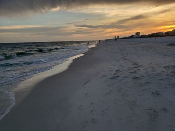 Scenic view of beach against sky during sunset