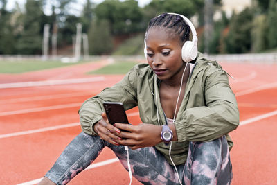 Full length of young woman using mobile phone